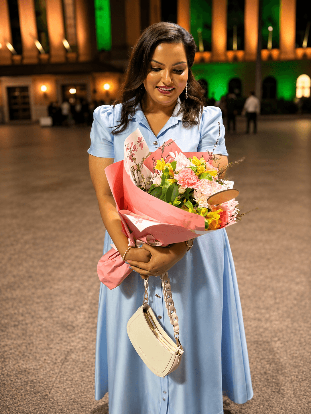 Engagement celebration makeup and styling, evening outdoor setting with flowers