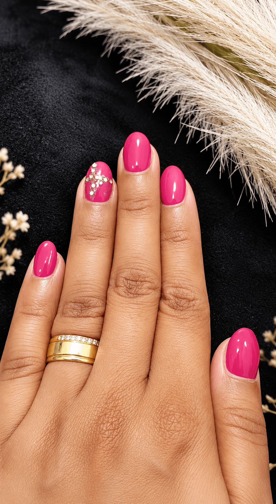 Nail styling detail, pink polish with accent design