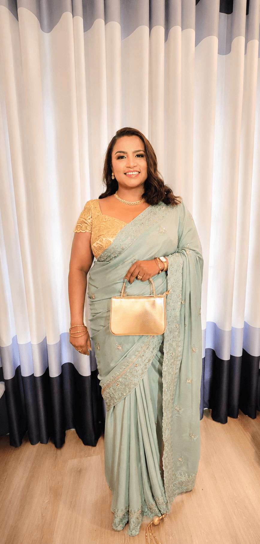 Special-occasion makeup and styling with a sage green saree